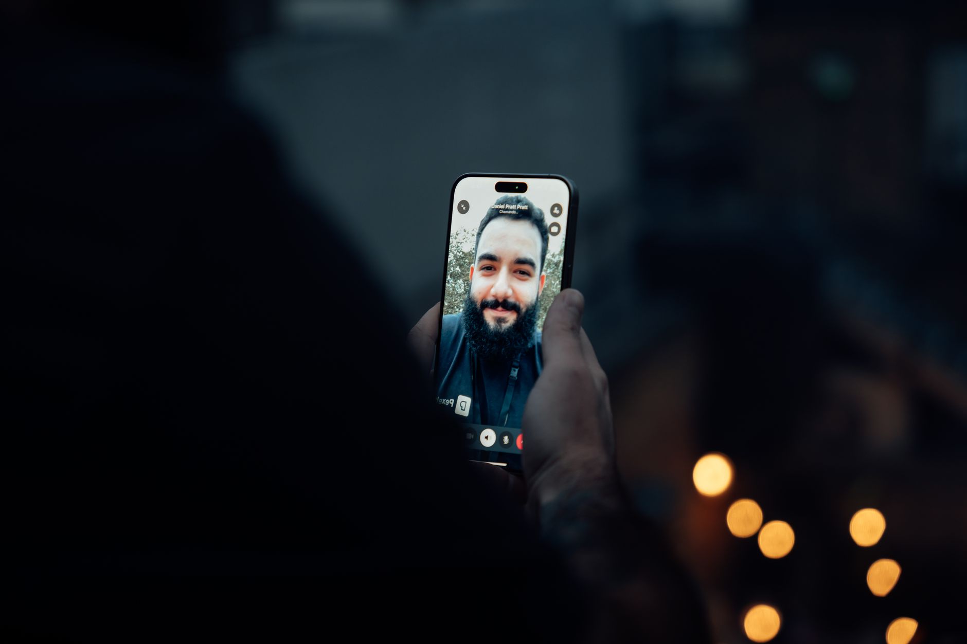 Homem conferindo o rosto no celular à noite